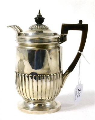 Lot 290 - A silver hot water jug with gadrooned decoration and engraved with a crest