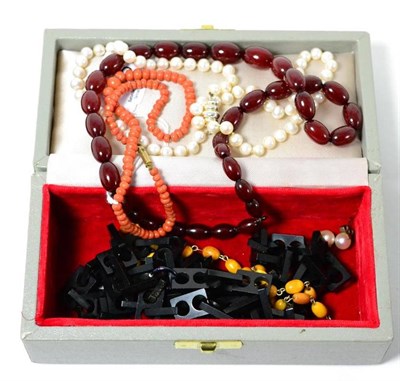 Lot 315 - A jet necklace, a coral necklace, an amber bead necklace, a red bead necklace and a cultured...