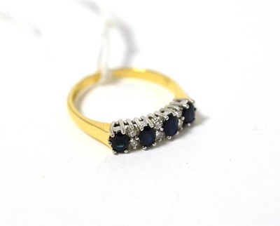 Lot 319 - An 18ct gold sapphire and diamond half hoop ring