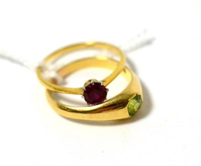 Lot 344 - A peridot set ring and a red stone set ring, stamped '18CT'