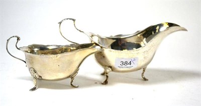 Lot 384 - A George II style silver sauce boat, by Mappin & Webb, London; together with a smaller example,...