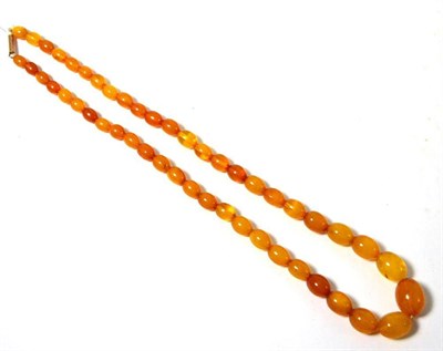 Lot 387 - A single strand of amber coloured beads