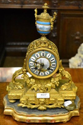 Lot 407 - A gilt metal and porcelain mounted striking mantel clock, with gilt wooden base