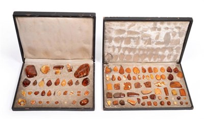 Lot 503 - Amber: a fitted box of thirty-five various amber specimens, cut into diverse shapes, including...