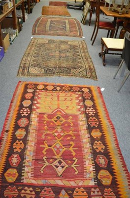 Lot 1012 - A Balouch rug, West Afghanistan, the indigo field of tribal motifs around a hooked medallion,...