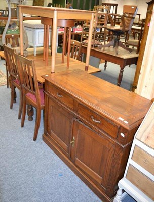 Lot 1016 - An oak side cupboard, twin drawers over two cupboard doors, plinth base, an oak dining table,...