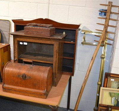 Lot 1045 - An oak glazed hanging cupboard, brass fender, sewing machine, framed tapestry etc