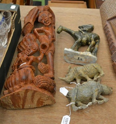 Lot 1091 - A carved wood group of figures collecting water, an Asante type carved soapstone equestrian...