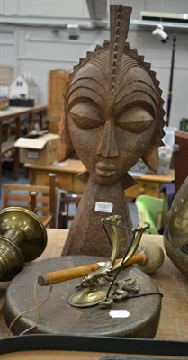 Lot 1097 - An African carved palm wood bust and a gong with wall bracket (2)