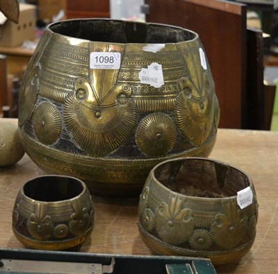 Lot 1098 - Three graduated Middle Eastern brass mounted turned wooden vessels