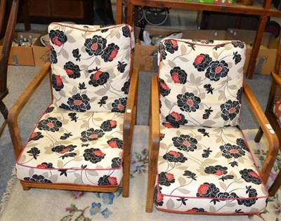 Lot 1128 - A pair of 1920's/30's limed oak adjustable reading chairs