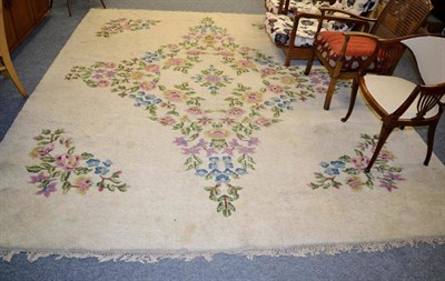 Lot 1130 - An Indian carpet, the cream filed with a floral medallion framed by spandrels 312cm by 276cm