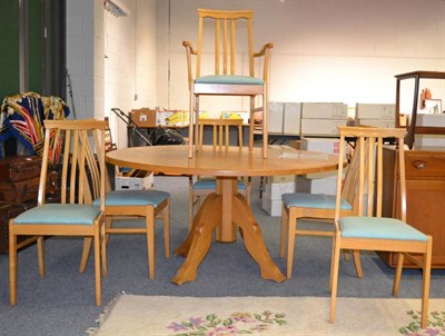 Lot 1131 - Bespoke solid oak dining table with stylised legs, 152cm diameter, together with six chairs