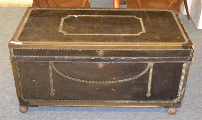 Lot 1136 - A 19th century leather covered brass bound and close nailed trunk