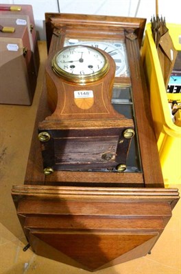 Lot 1148 - An Edwardian mahogany balloon clock, Arabic dial, twin train movement, together with a mahogany...