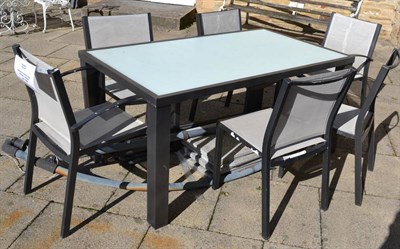 Lot 1162 - Modern glass topped and metal based garden table with six chairs, together with parasol (canvas...