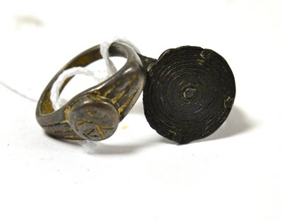 Lot 14 - A heavy Roman silver ring, along with a further bronze spiral designed ring