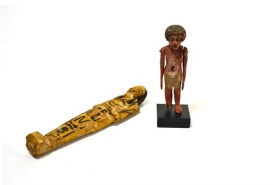 Lot 24 - An Egyptian carved wooden model of a slave, Late Period circa 6th-3rd century BC, with...