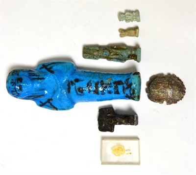 Lot 28 - An Egyptian miniature blue faience amulet of Anubis, Late Period, circa 600-30 BC, wearing...