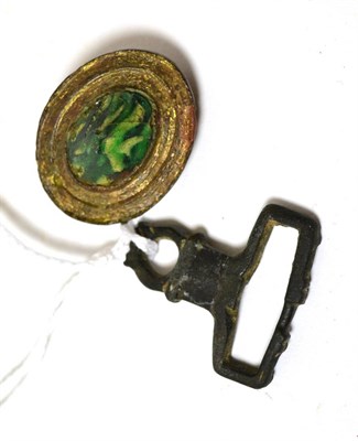 Lot 36 - A Roman bronze variegated green glass cabochon mounted brooch, circa 2nd-3rd century AD, 3cm...