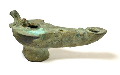 Lot 44 - A Roman cast bronze piriform oil lamp, circa 1st-2nd century AD, the handle now missing, raised...