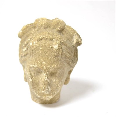Lot 47 - A Greek or Roman stucco head of a Godess, modelled in the round , having centrally parted hair...