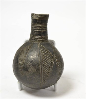 Lot 55 - A Syrian black terracotta bottle vase, circa 15th-17th century AD, of continuous geometric...