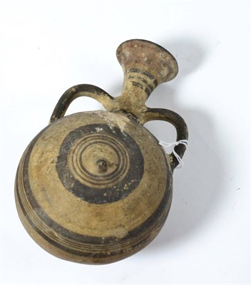 Lot 67 - An Eastern Mediterranean terracotta moon flask with twin handles, circa 5th-3rd century BC, the...