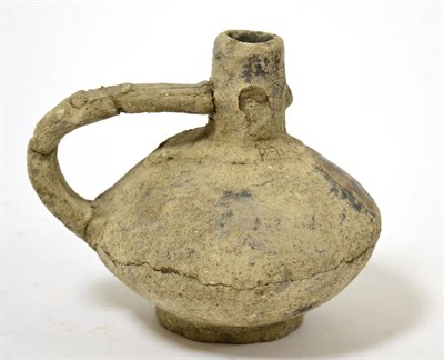 Lot 82 - An Eastern Mediterranean terracotta jug, with face to neck, 5th-3rd century BC, of squat form, 14cm