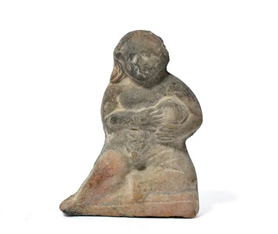 Lot 83 - A Romano Egyptian or Greek terracotta figure holding a vessel, 2nd century BC-AD, modelled in...