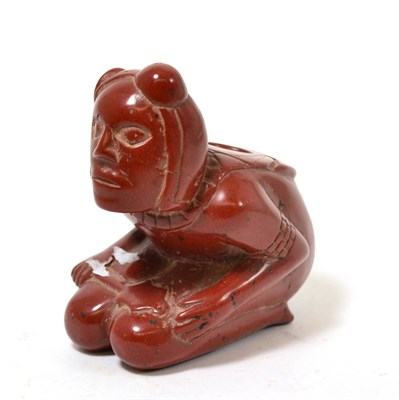 Lot 92 - An Amerindian carved red hardstone figural pipe, 19th-20th century, in the style of an earlier pipe