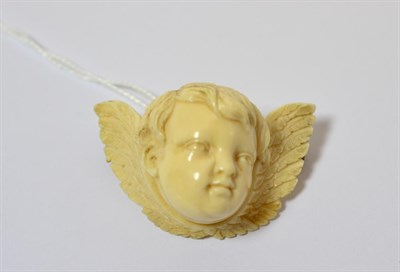 Lot 205 - A late 19th century ivory winged cherub brooch