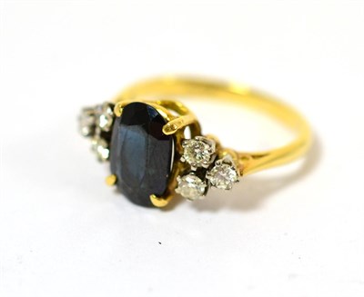 Lot 232 - A sapphire and diamond ring on an 18ct gold band