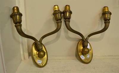 Lot 250 - A pair of Art Deco brass double wall lights/sconces, on oval backs, unmarked, 40cm