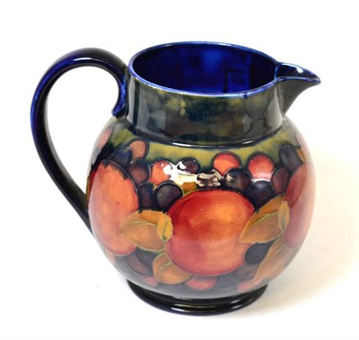 Lot 268 - A William Moorcroft Pomegranate Pattern jug, on a blue ground, impressed factory marks,...