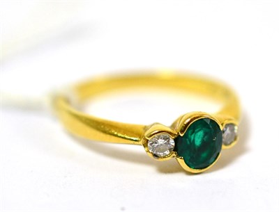 Lot 330 - An emerald and diamond three stone ring