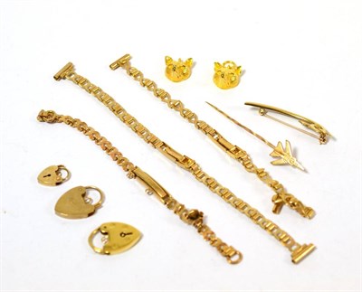 Lot 348 - A group of 9ct gold including three padlock charms, two fox head charms, a stick pin, a bar...