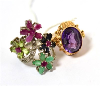 Lot 359 - A synthetic sapphire imitating alexandrite, in ornate ring mount and a multi-gemstone ring...