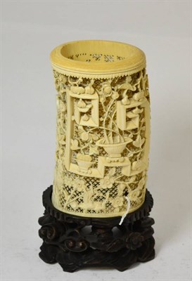 Lot 385 - An early 20th century Chinese ivory carving decorated with birds and foliage on a hardwood stand