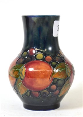 Lot 387 - A William Moorcroft Pomegranate Pattern vase, on a blue ground, impressed facsimile signature...