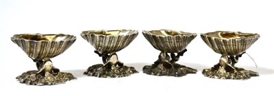 Lot 390 - A set of four salts with shell bowls and dolphin supports, impressed with a crest