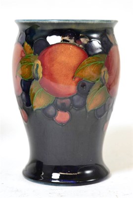 Lot 392 - A William Moorcroft Pomegranate pattern vase, on a blue ground, impressed factory marks, blue...