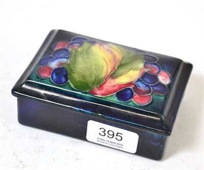 Lot 395 - A William Moorcroft Leaf and Grape pattern box and cover, on a blue ground, impressed POTTER TO H.M