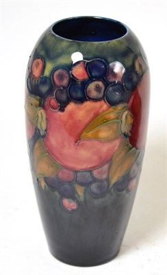 Lot 396 - A William Moorcroft Pomegranate pattern vase, on a blue ground, impressed factory marks, blue...