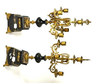 Lot 422 - A pair of gilt metal four light candelabra raised on stepped marble plinth bases in period style