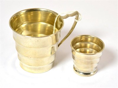 Lot 501 - A Hukin & Heath silver christening cup, Birmingham 1938 together with a matching egg cup (2)