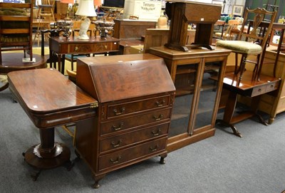 Lot 1035 - A 19th century mahogany fold over table together with an oak occasional table and a bureau (3)