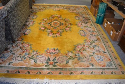 Lot 1123 - Chinese carved carpet, the mustard field centred by an oval medallion framed by floral borders,...