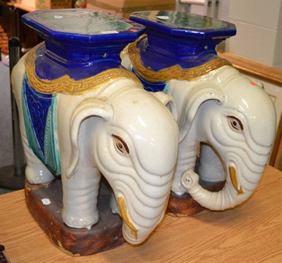 Lot 1133 - A pair of large Chinese pottery elephant garden seats, in cream glaze, 55cm high