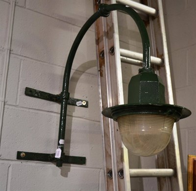 Lot 1151 - A large green painted cast iron wall mounted arched street light by REVO